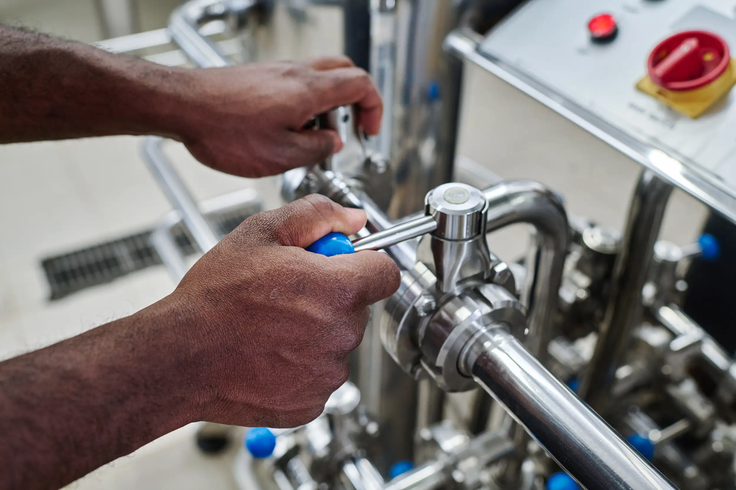 A hand checking the pipe levers.