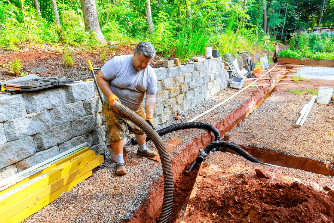 man digging the ground for the tubes set up