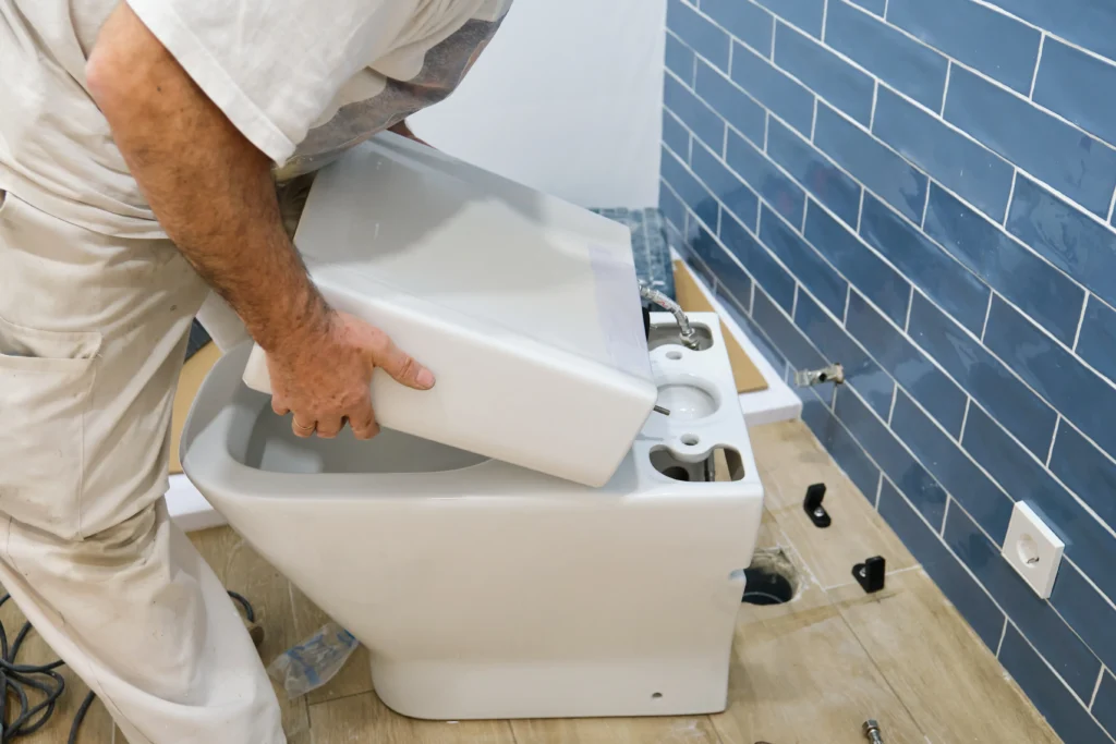 An image of a plumber assembling and installing the toilet.